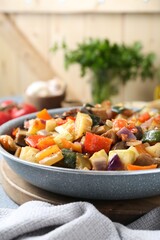Delicious ratatouille in frying pan on board, closeup. Space for text