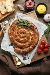 Delicious homemade sausage with spices served on wooden table, flat lay