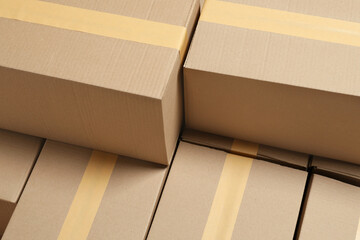 Many closed cardboard boxes as background. Packaging goods