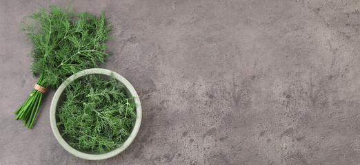 Fresh dill on grey table, top view. Banner design with space for text