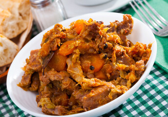 Tasty stew of cabbage with boneless pork and sliced carrots..