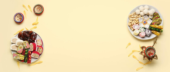 Plates with Indian treats and lamps on beige background with space for text. Divaly celebration