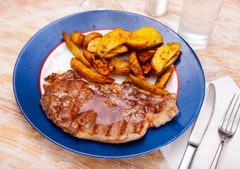 Juicy beef entrecote with baked potato. Delicious homemade dinner..