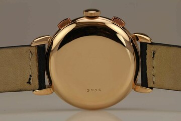 Rose gold watch caseback with a number engraved on it