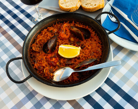 Popular dish of Spanish cuisine is paella with seafood, made from rice with saffron soaked in the aroma and taste of ..the gifts of the sea