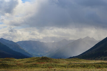 Rain clouds over a glacial valley and mountains in Alaska.