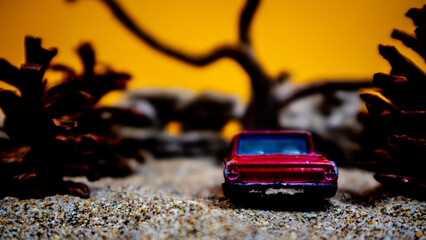 Minahasa, Indonesia - December 9, 2022: a toy car among the pinecones