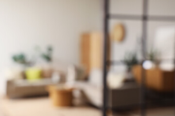 Blurred view of living room interior with grey sofas and coffee table