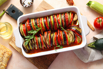 Baking dish of tasty Ratatouille on beige background