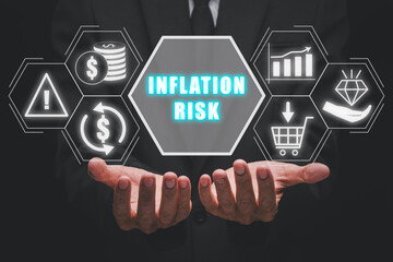 Inflation risk concept, Businessman hand holding inflation risk icon on virtual screen.