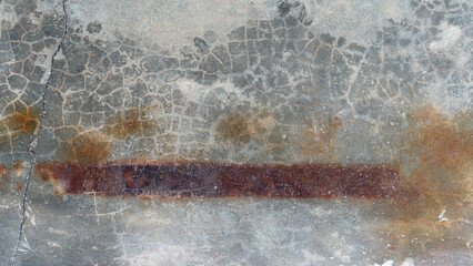 Above view of old cement floor with long lines of rust stains on it. For background and textured.