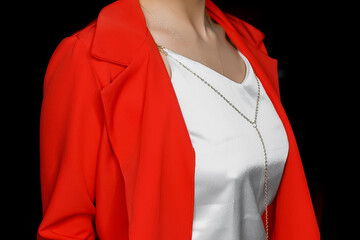 Stylish fashionable girl posing in a white T-shirt and a red jacket on a isolated black background