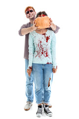 Scary zombies with pumpkin on white background