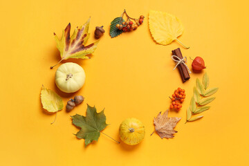 Frame made of natural forest decor and pumpkins on color background