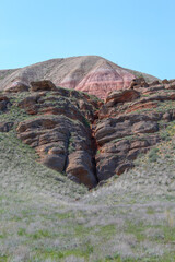 Big Bogdo mountain. Red sandstone outcrops on the slopes sacred mountain