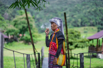 Girl smoking, smoke comes out of her mouth. Woman Smoking a Cigarette. Karen hill tribe women...