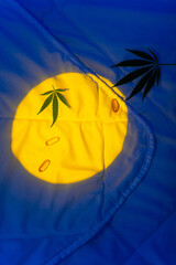 Background for cannabis product to sleep Light of moon on blanket with marijuana