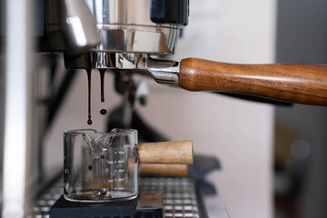 espresso shot with bottomless portafilter on a professional coffee machine