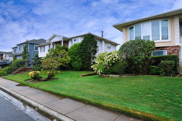American suburban street with large detached houses with front lawns
