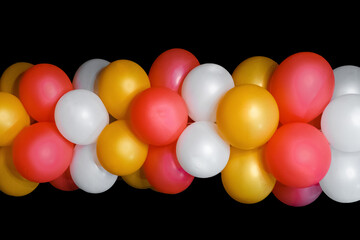 Colored helium air balloons for a holiday, festival or birthday celebration object on black background
