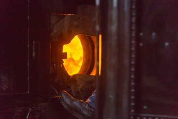 Blacksmith forging metal with tools