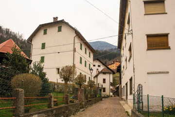 Fototapeta na wymiar A street in the mountain village of Magnanins near Rigolato in Carnia, Friuli-Venezia Giulia, north east Italy