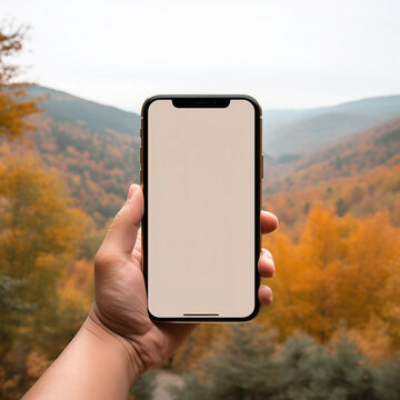 A Hand Holding a Smartphone Taking a Picture of Autumn Trees With Copy Space