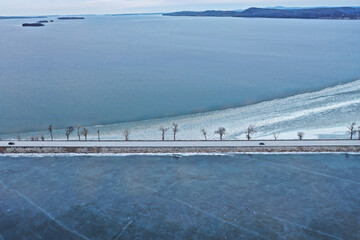 Dreamy aerial view of frozen Lake Champlain in the winter with reflective ice