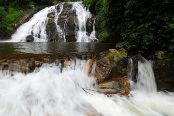 Water flowing down a cascade waterfall with motion blur