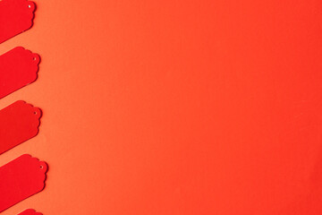 Obraz premium Row of red price tags with copy space on red background