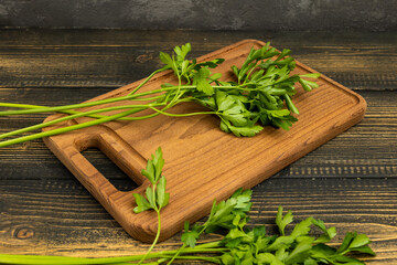 parsley for salad on a cutting board on a wooden table