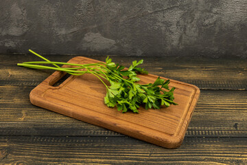 parsley for salad on a cutting board on a wooden table