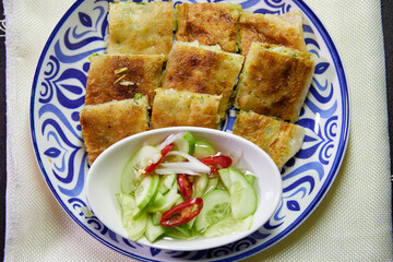 Roti mataba and sauce cup in plate