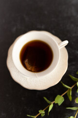 A cup of black tea in a white tea cup