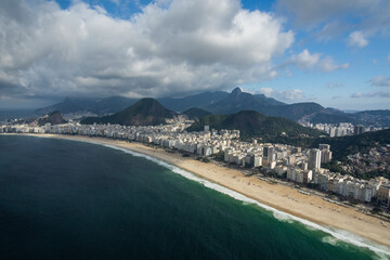 Beautiful aerial view to ocean beach and city buildings in Rio