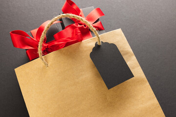 Gift boxes with ribbon, gift bag with copy space over black background