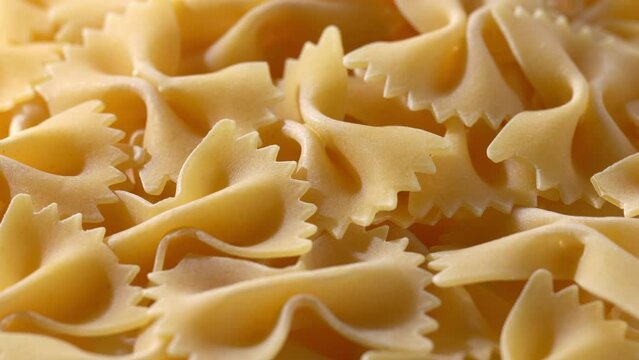 Close-up video of dried pasta. Farfalle. rotation.