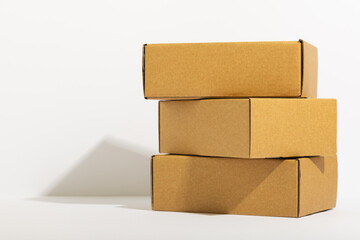 Stack of cardboard gift boxes with copy space over white background