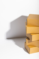 Vertical image of stack of cardboard gift boxes with copy space over white background