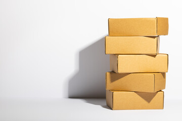 Stack of cardboard gift boxes with copy space over white background