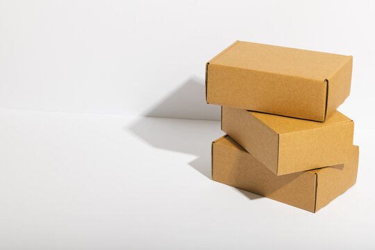 Stack of cardboard gift boxes with copy space over white background