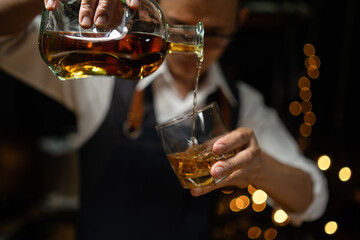 Barman pouring whiskey whiskey glass beautiful night