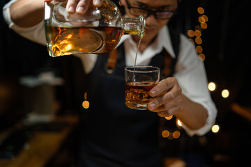 Barman pouring whiskey whiskey glass beautiful night