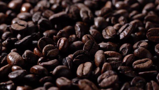 Close-up video of rotating roasted coffee beans.