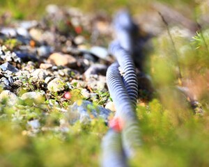 Close up of pair of steel cables lying outside on the ground