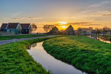 Sunrise at Zaanse Schans village with Dutch traditional house near Amsterdam Netherlands - 647978957