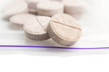 Round therapeutic pills or drugs for treatment on white background, medicine and healthcare concept, close-up view