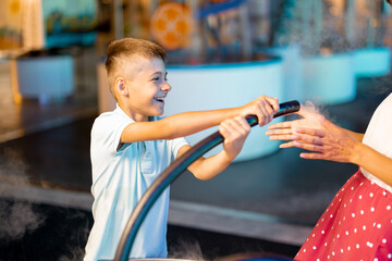 Little boy make soap bubbles, while playing together and having fun in a science museum. Concept of children's entertainment and learning