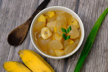 Kolak Pisang is a sweet dessert made from banana, sugar palm fruit, brown sugar, coconut milk, pandan leaves, cloves, and cinnamon. This dish is popular during the month of Ramadan. Indonesian food. 