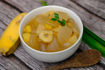 Kolak Pisang is a sweet dessert made from banana, sugar palm fruit, brown sugar, coconut milk, pandan leaves, cloves, and cinnamon. This dish is popular during the month of Ramadan. Indonesian food. 